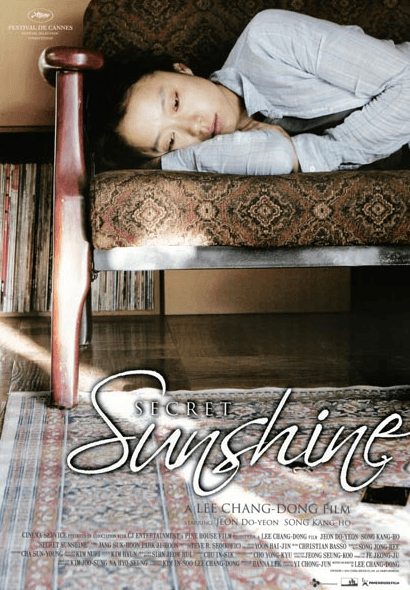 ecret Sunshine (2007) movie poster featuring Shin-ae (Jeon Do-yeon) looking up with a complex expression of grief and longing under harsh sunlight.